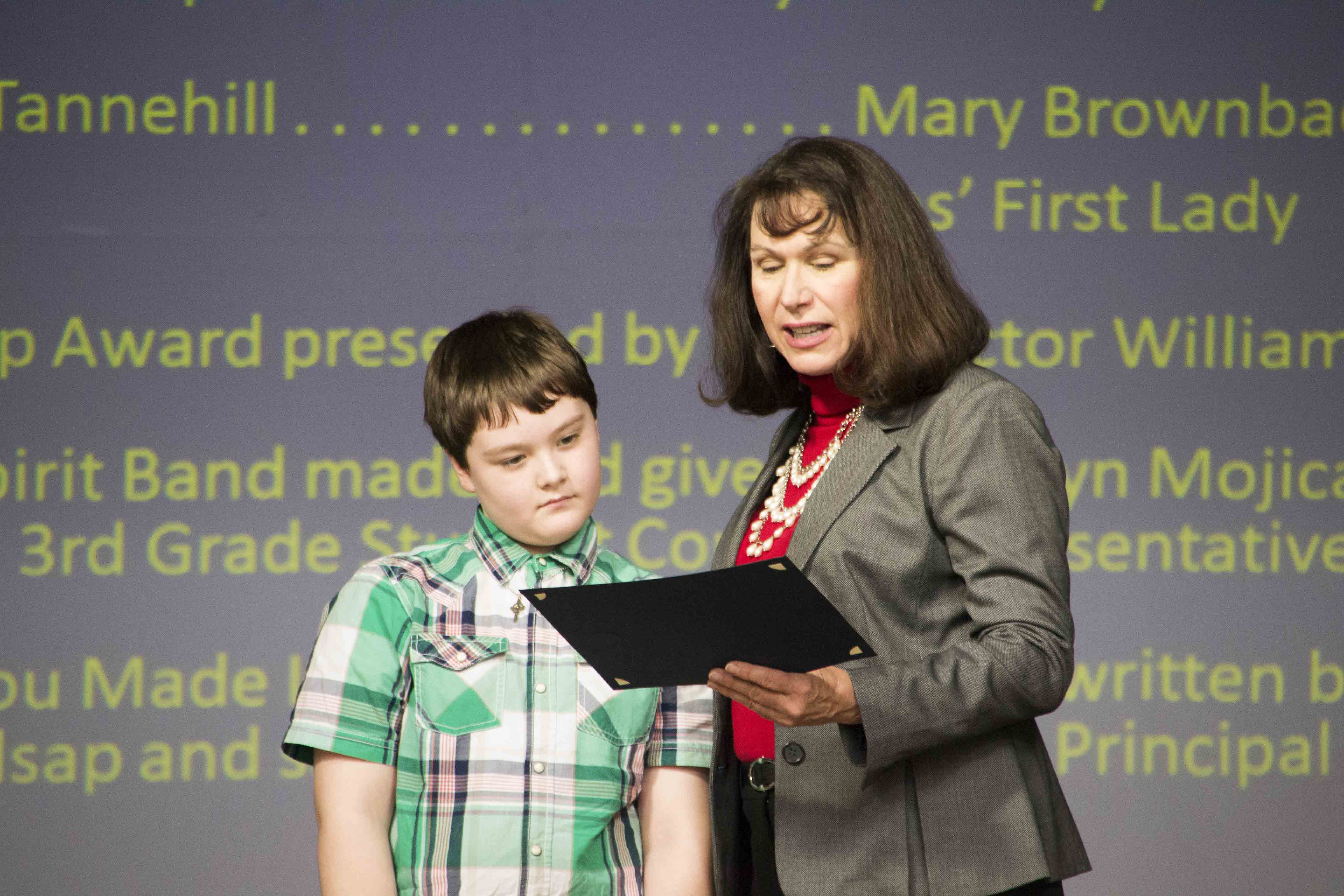 First Lady Mary Brownback hands Connor a certificate